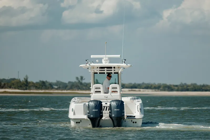  Yacht Photos Pics 2013 Boston Whaler 320 Outrage boat cruising on open water with twin engines.