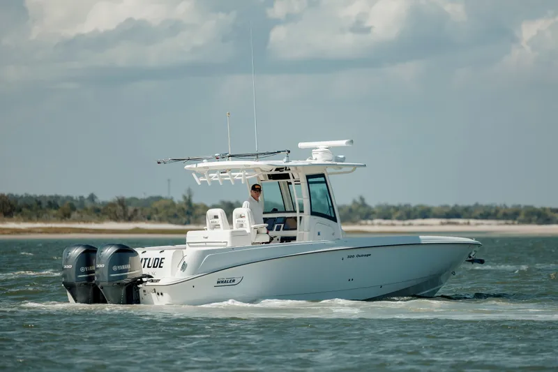  Yacht Photos Pics 2013 Boston Whaler 320 Outrage boat cruising on open water.