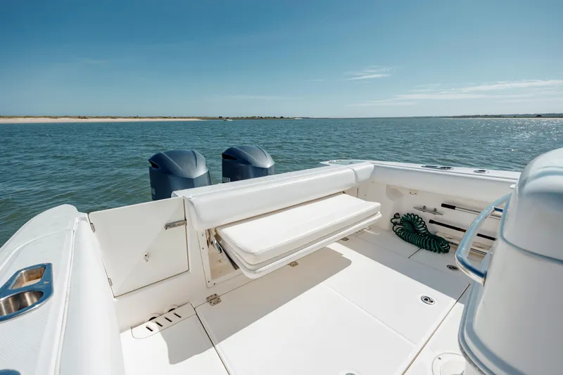  Yacht Photos Pics 2013 Boston Whaler 320 Outrage boat on calm water, featuring dual engines and spacious deck.
