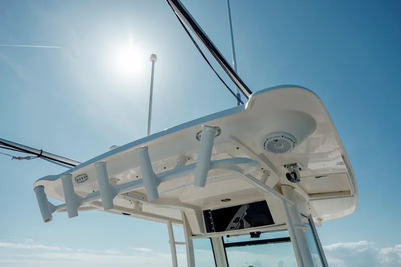  Yacht Photos Pics Boston Whaler 320 Outrage 2013 boat canopy under clear blue sky.