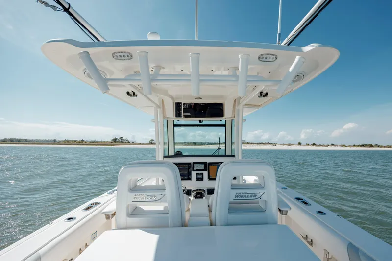  Yacht Photos Pics 2013 Boston Whaler 320 Outrage boat interior with ocean view and clear sky.