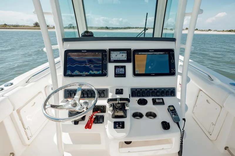  Yacht Photos Pics 2013 Boston Whaler 320 Outrage helm with advanced navigation and control systems on open water.