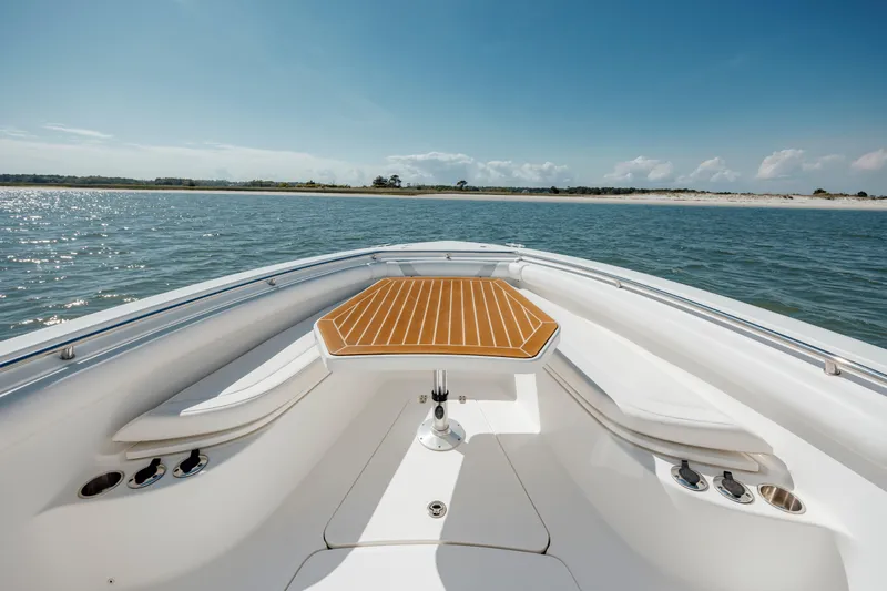  Yacht Photos Pics 2013 Boston Whaler 320 Outrage boat on calm water, featuring a spacious deck.