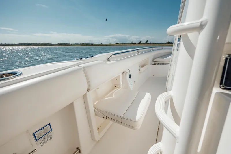  Yacht Photos Pics 2013 Boston Whaler 320 Outrage boat interior with seating, on a sunny day at sea.