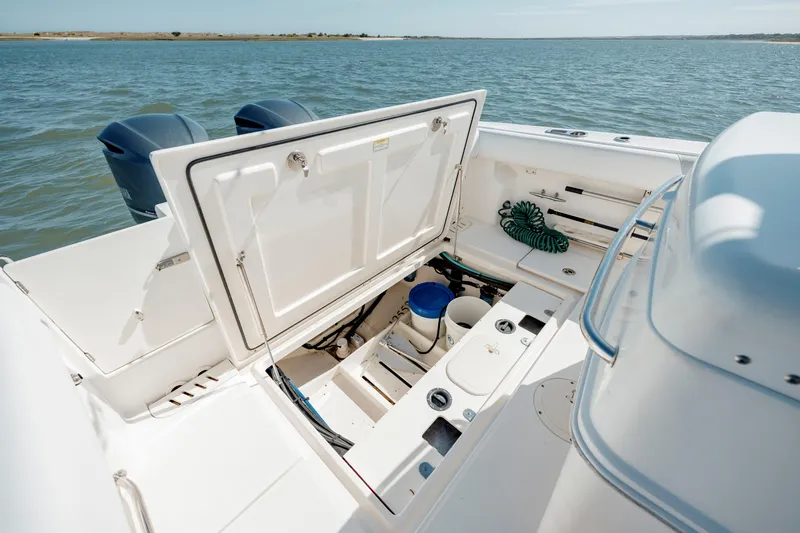  Yacht Photos Pics 2013 Boston Whaler 320 Outrage boat with open storage compartment, ocean view.