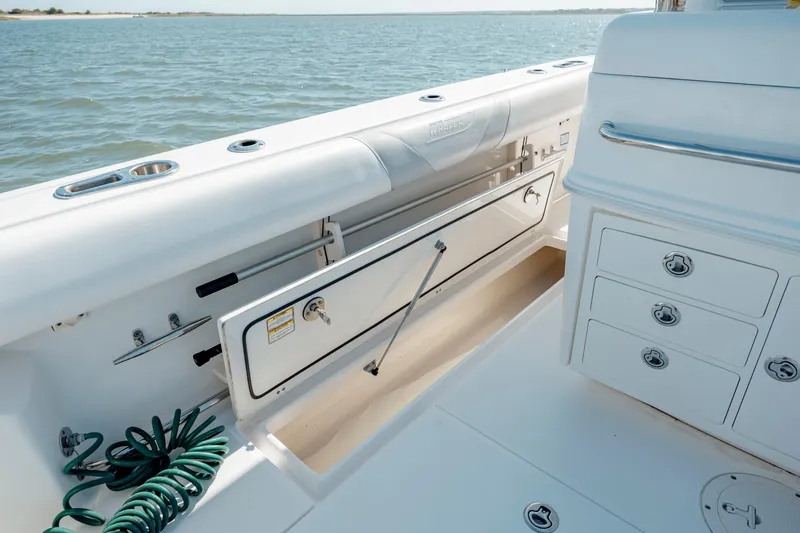  Yacht Photos Pics 2013 Boston Whaler 320 Outrage boat interior with storage compartments and ocean view.