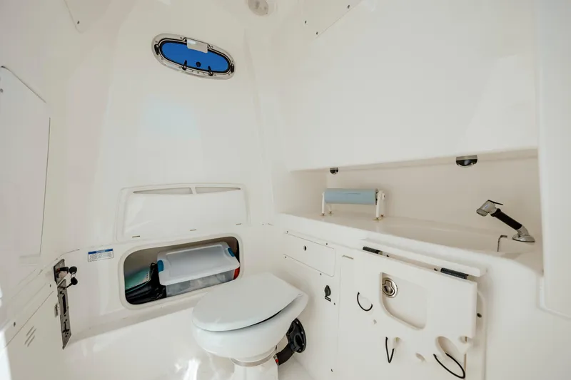  Yacht Photos Pics Interior of 2013 Boston Whaler 320 Outrage boat, featuring a compact marine toilet.