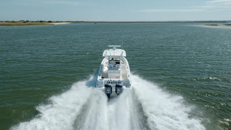  Yacht Photos Pics 2013 Boston Whaler 320 Outrage speeding on open water, creating a wake.