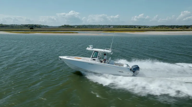  Yacht Photos Pics 2013 Boston Whaler 320 Outrage cruising on open water, showcasing speed and performance.