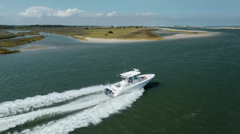  Yacht Photos Pics 2013 Boston Whaler 320 Outrage cruising on a scenic waterway.