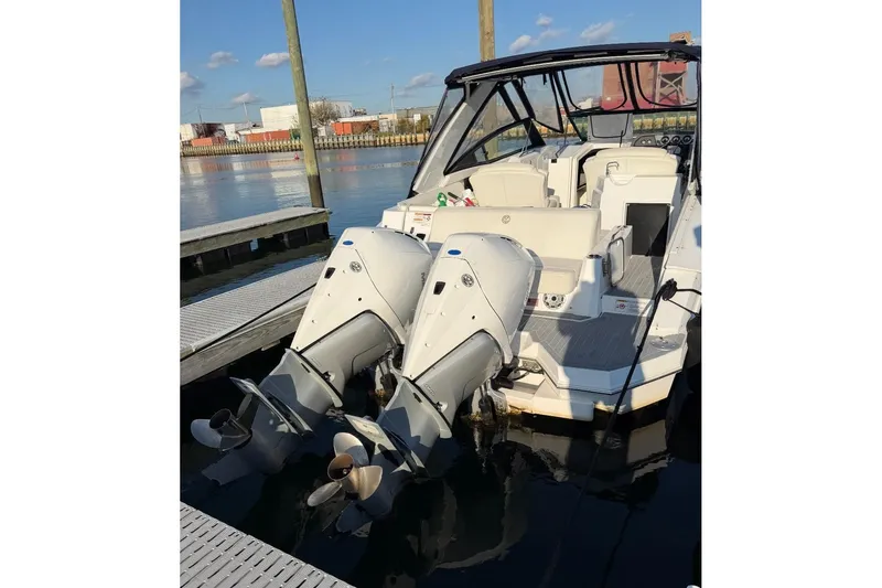  Yacht Photos Pics 2021 Cruisers Yachts 338 Outboard with dual engines docked at marina.