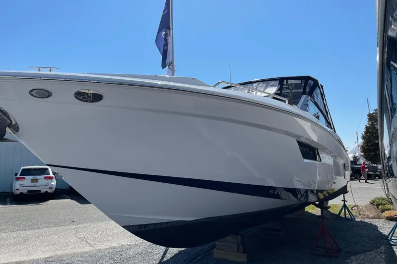  Yacht Photos Pics 2021 Cruisers Yachts 338 Outboard boat displayed outdoors on a sunny day.