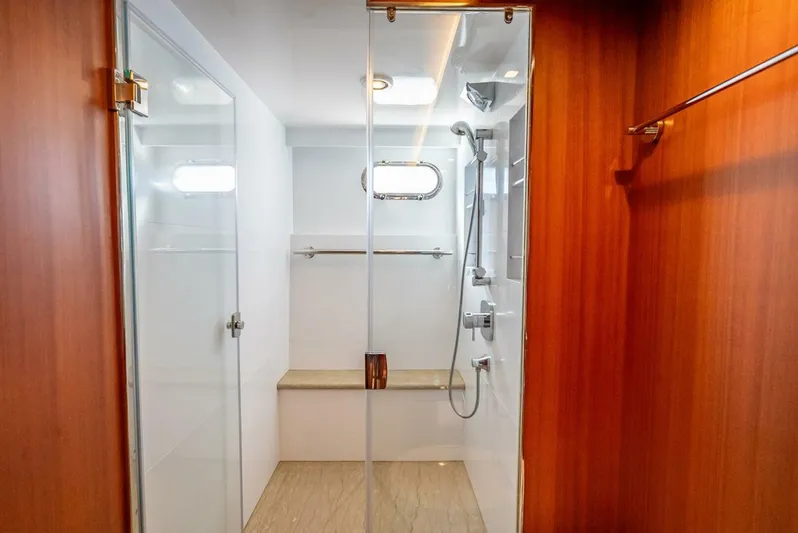Sunny Seajay Yacht Photos Pics Modern shower area in 2022 Hampton 658l Endurance yacht, featuring glass doors and wooden accents.