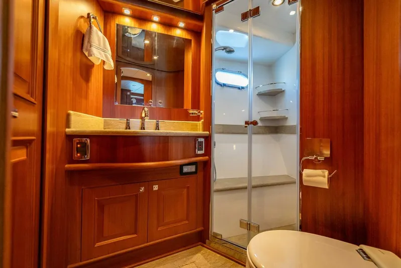 Sunny Seajay Yacht Photos Pics Luxurious bathroom in 2022 Hampton 658l Endurance yacht with wood finishes and glass shower.