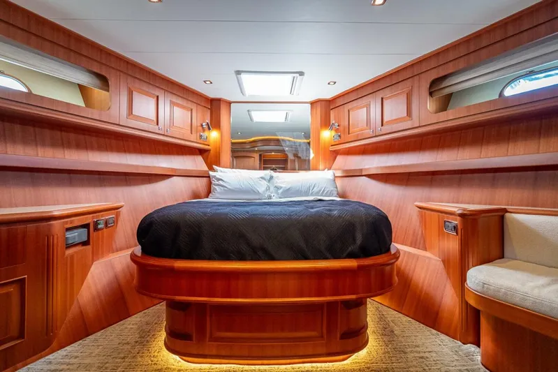 Sunny Seajay Yacht Photos Pics Luxurious cabin interior of 2022 Hampton 658l Endurance yacht with wood paneling and cozy bed.