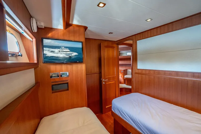 Sunny Seajay Yacht Photos Pics Luxurious cabin interior of 2022 Hampton 658l Endurance yacht with twin beds and wooden finish.