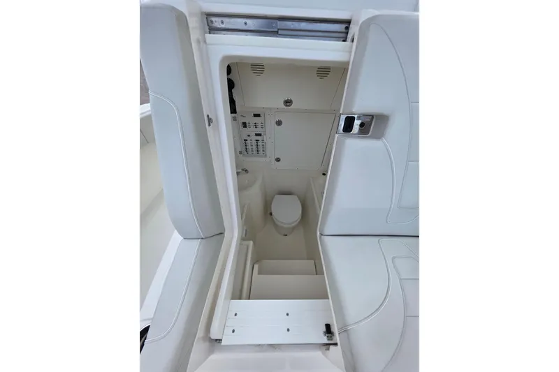 Seavee Yacht Photos Pics 2022 SeaVee 340Z boat interior with compact marine toilet and storage area.