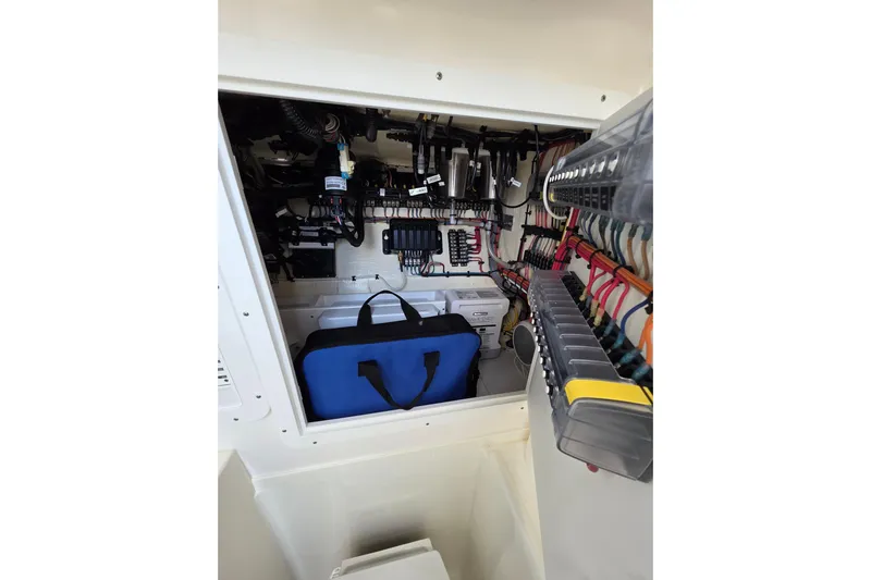 Seavee Yacht Photos Pics 2022 SeaVee 340Z electrical compartment with organized wiring and storage bag.