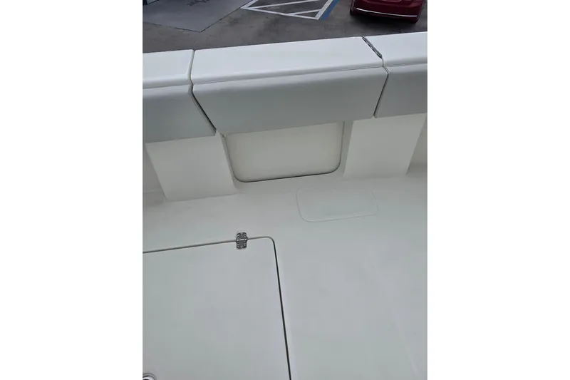 Seavee Yacht Photos Pics 2022 SeaVee 340Z boat interior detail with cushioned seating and storage compartment.