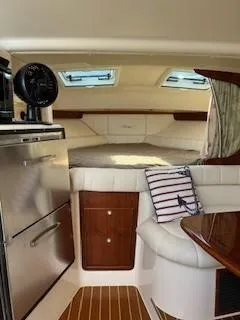  Yacht Photos Pics 2008 Grady-White Express 360 cabin interior with bed, fridge, and wood accents.