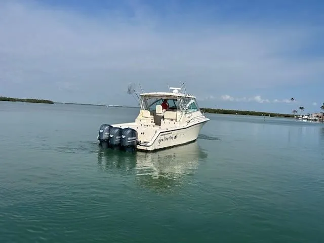  Yacht Photos Pics 2008 Grady-White Express 360 boat on calm water under clear blue sky.