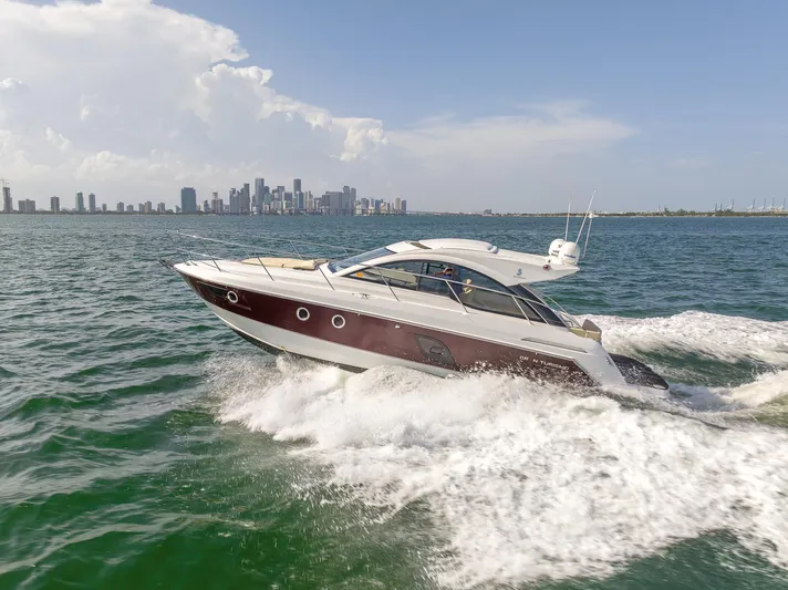 Ms Bordeaux Yacht Photos Pics 2013 Beneteau GRAN TURISMO 38 cruising on open water with city skyline backdrop.