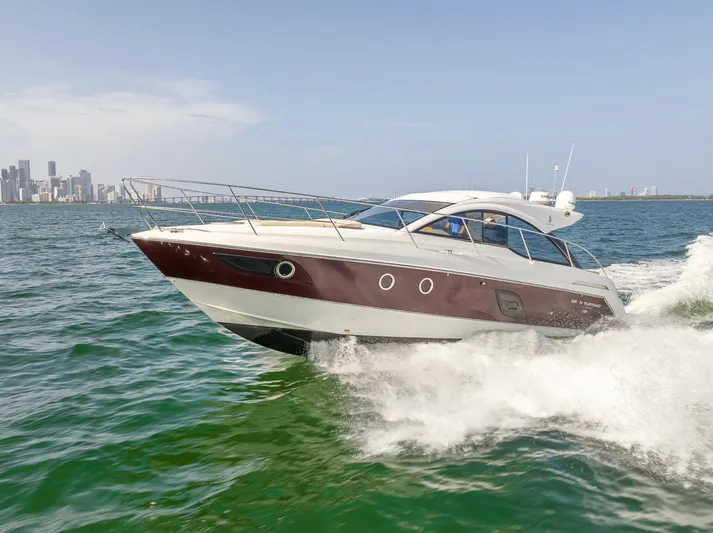 Ms Bordeaux Yacht Photos Pics 2013 Beneteau Gran Turismo 38 cruising on open water near city skyline.