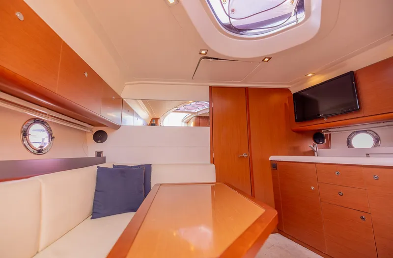 Ms Bordeaux Yacht Photos Pics Interior of 2013 Beneteau Gran Turismo 38 yacht with modern wood finish and seating area.
