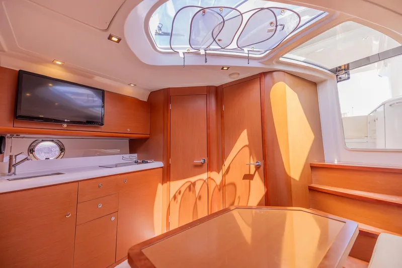 Ms Bordeaux Yacht Photos Pics Luxurious interior of 2013 Beneteau Gran Turismo 38 yacht with modern amenities and elegant wood finish.