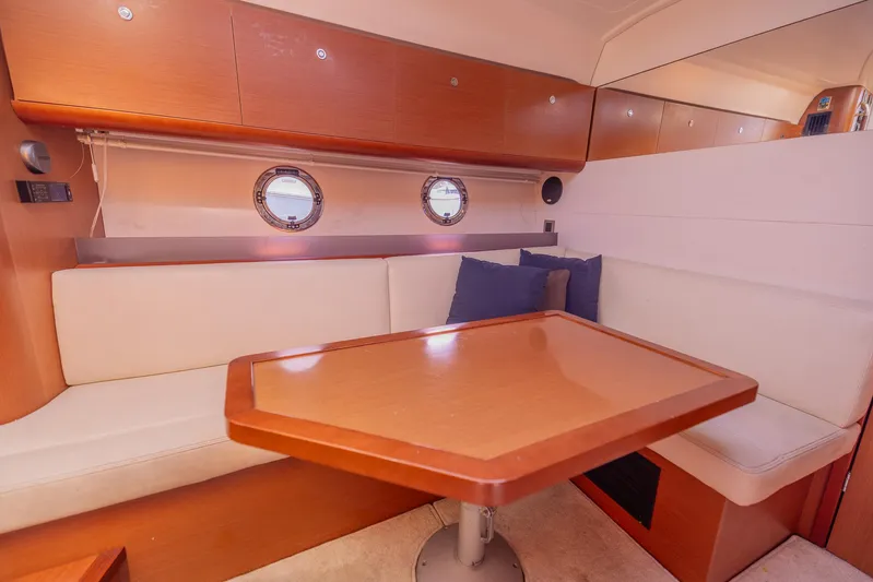 Ms Bordeaux Yacht Photos Pics Interior of 2013 Beneteau Gran Turismo 38 yacht with cozy seating and wooden table.