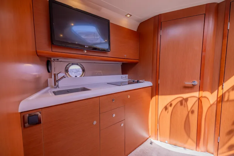 Ms Bordeaux Yacht Photos Pics Interior of 2013 Beneteau GRAN TURISMO 38 yacht with kitchenette and TV.