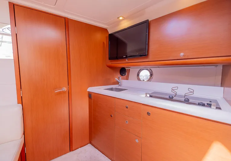Ms Bordeaux Yacht Photos Pics Interior of 2013 Beneteau Gran Turismo 38 yacht with kitchenette and TV.