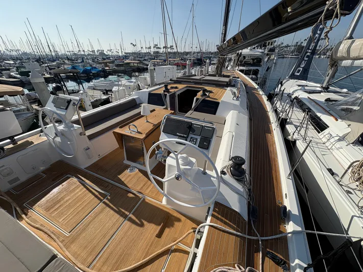 560 Exclusive Yacht Photos Pics Dufour 560 Exclusive 2018 yacht with dual steering wheels and teak deck in marina.