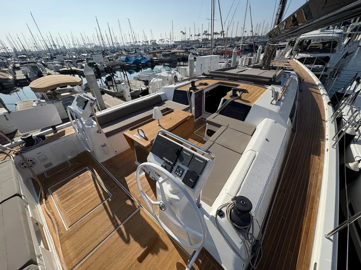 560 Exclusive Yacht Photos Pics Luxurious 2018 Dufour 560 Exclusive yacht with spacious deck and modern helm, docked at marina.