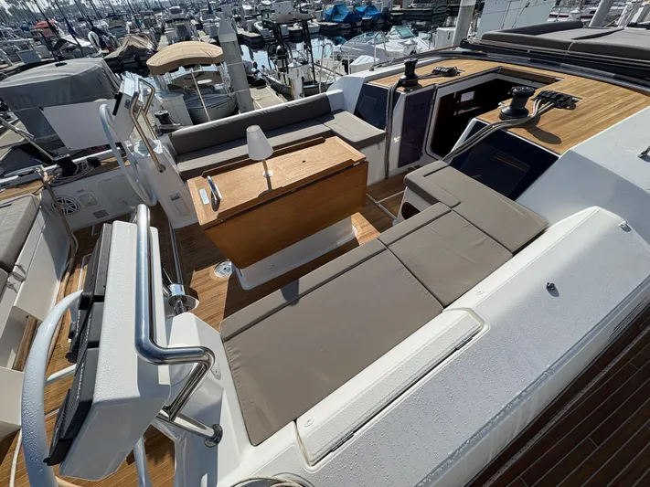 560 Exclusive Yacht Photos Pics Dufour 560 Exclusive 2018 yacht deck with seating and helm, docked at marina.