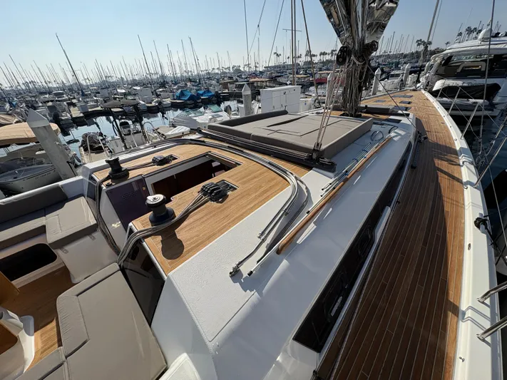 560 Exclusive Yacht Photos Pics 2018 Dufour 560 Exclusive yacht with sleek deck design in a marina setting.