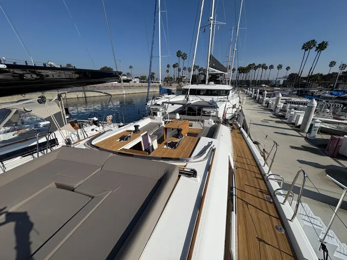 560 Exclusive Yacht Photos Pics 2018 Dufour 560 Exclusive yacht docked at marina, showcasing spacious deck and elegant design.