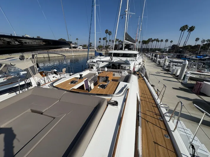 560 Exclusive Yacht Photos Pics 2018 Dufour 560 Exclusive yacht docked at marina, showcasing spacious deck and sleek design.