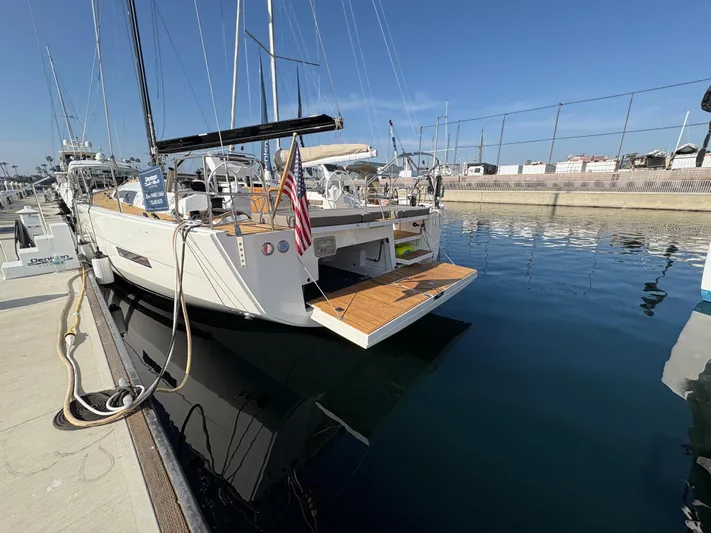 560 Exclusive Yacht Photos Pics Dufour 560 Exclusive 2018 yacht docked at marina, rear view with open swim platform.