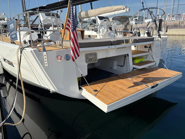 560 Exclusive Yacht Photos Pics Dufour 560 Exclusive 2018 yacht with open swim platform, docked in a marina.