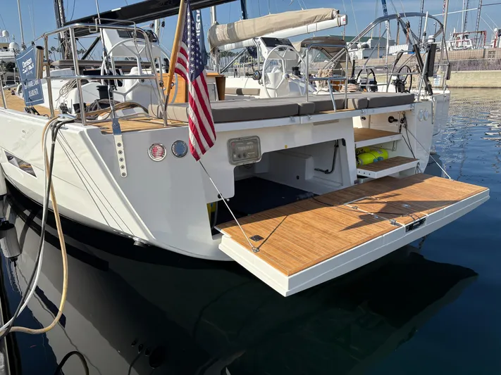560 Exclusive Yacht Photos Pics Dufour 560 Exclusive 2018 yacht with open swim platform, docked in marina.