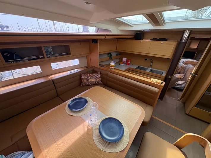 560 Exclusive Yacht Photos Pics Luxurious interior of 2018 Dufour 560 Exclusive yacht with elegant dining area and modern kitchen.