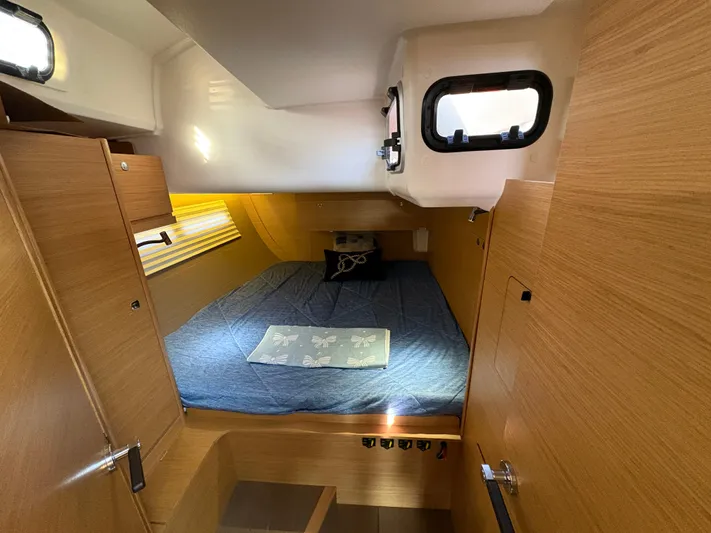 560 Exclusive Yacht Photos Pics Cabin interior of 2018 Dufour 560 Exclusive yacht with cozy bed and wooden finish.