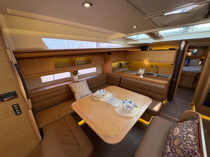 560 Exclusive Yacht Photos Pics Luxurious interior of 2018 Dufour 560 Exclusive yacht with elegant dining area and modern kitchen.