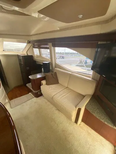  Yacht Photos Pics Interior of 2006 Sea Ray 44 Sedan Bridge with sofa and TV.