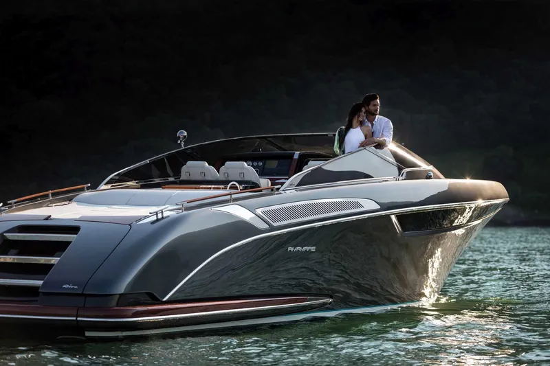  Yacht Photos Pics 2023 Riva 38 Rivamare luxury yacht cruising on water with couple onboard.