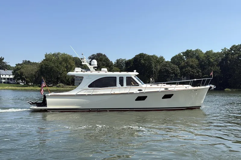  Yacht Photos Pics 2020 Vicem 50 Classic yacht cruising on a serene river with lush greenery.