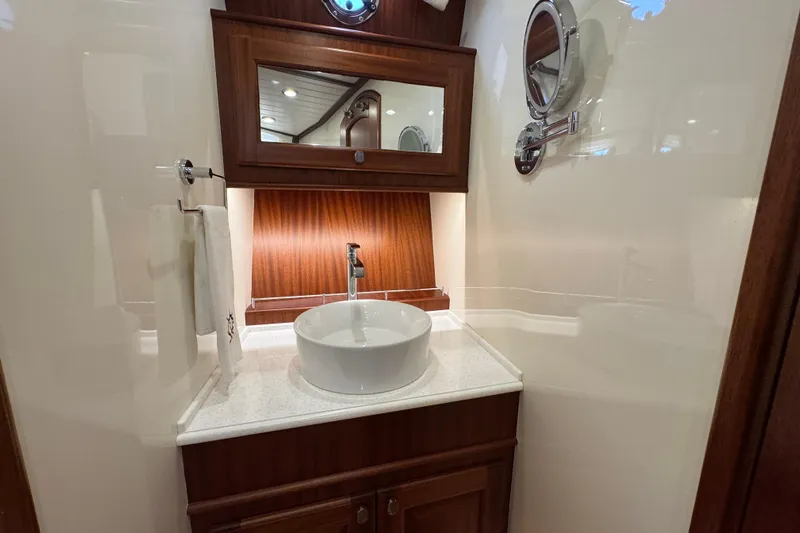  Yacht Photos Pics Elegant bathroom interior of 2020 Vicem 50 Classic yacht with modern sink and wooden accents.