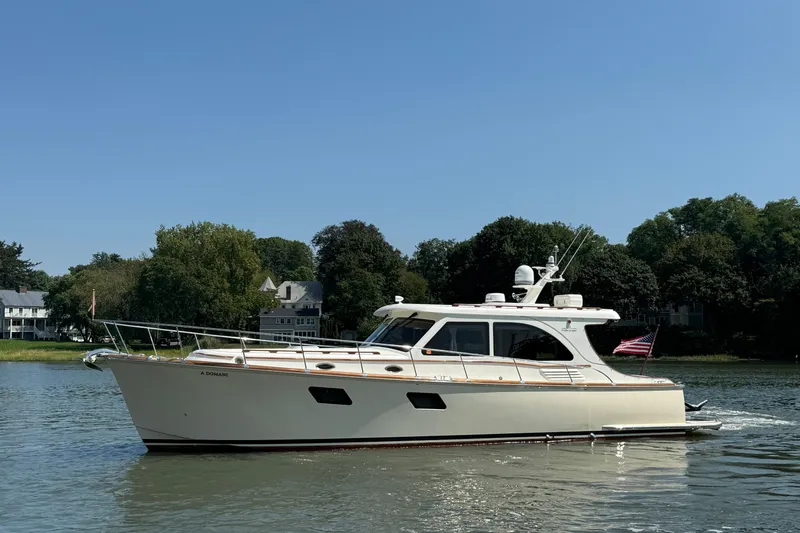  Yacht Photos Pics 2020 Vicem 50 Classic yacht cruising on a serene river with lush greenery.