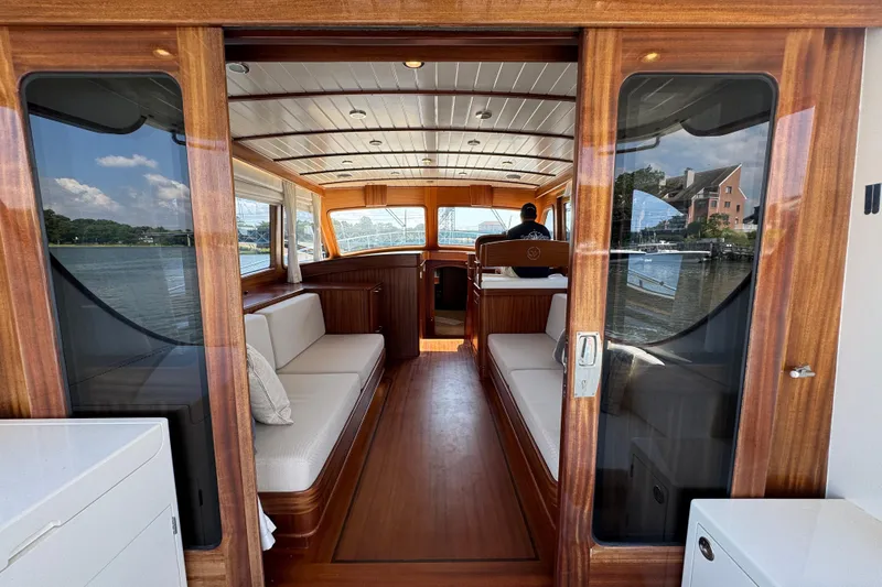  Yacht Photos Pics Interior view of 2020 Vicem 50 Classic yacht with elegant wood finish and seating.